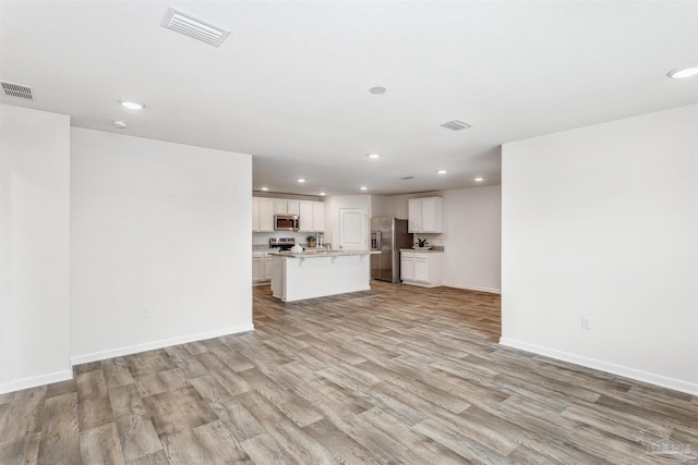 unfurnished living room featuring light wood-type flooring