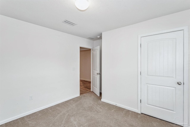 unfurnished bedroom with light colored carpet