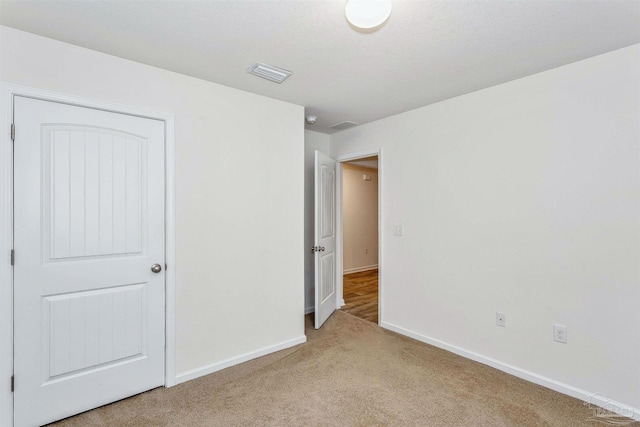 unfurnished bedroom with light carpet