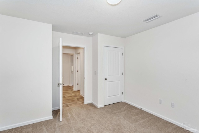 spare room with light colored carpet