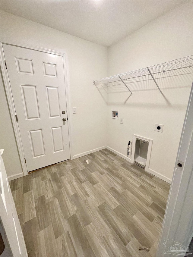 laundry area with light wood-type flooring, washer hookup, baseboards, hookup for an electric dryer, and laundry area