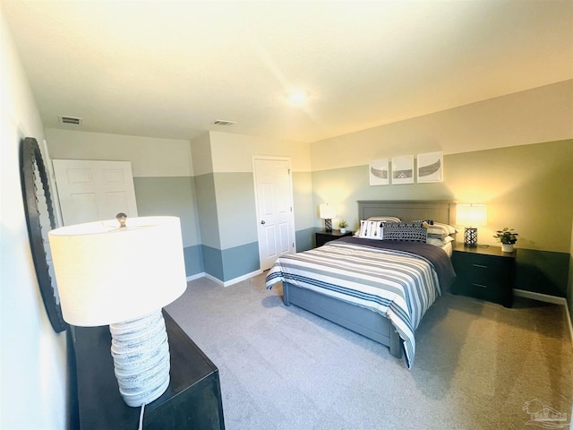 carpeted bedroom with baseboards and visible vents