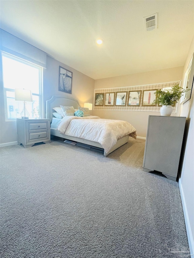 carpeted bedroom featuring visible vents and baseboards