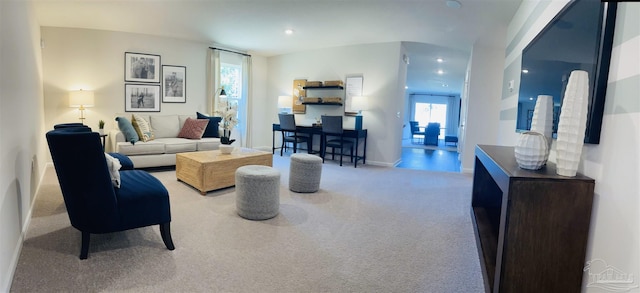 carpeted living room with recessed lighting and baseboards