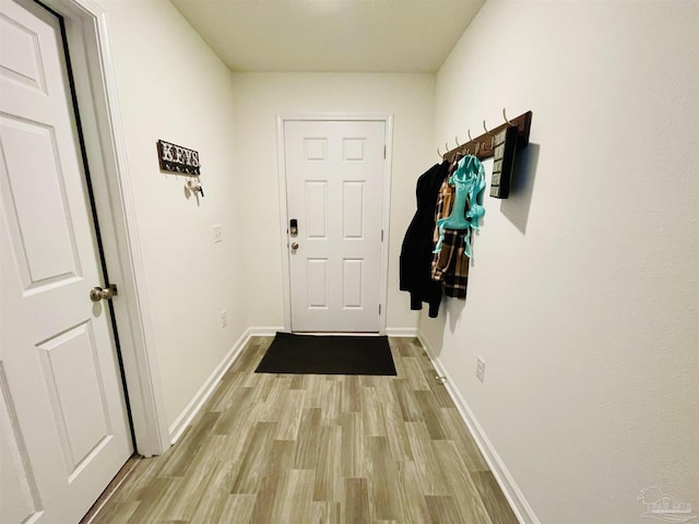 entryway with baseboards and light wood-style floors