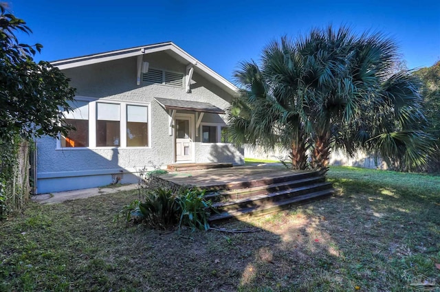 exterior space with a wooden deck and a front yard