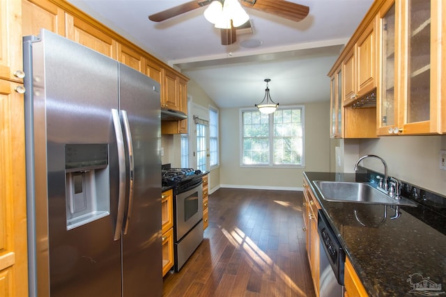 kitchen with sink, stainless steel appliances, dark hardwood / wood-style flooring, decorative light fixtures, and dark stone counters