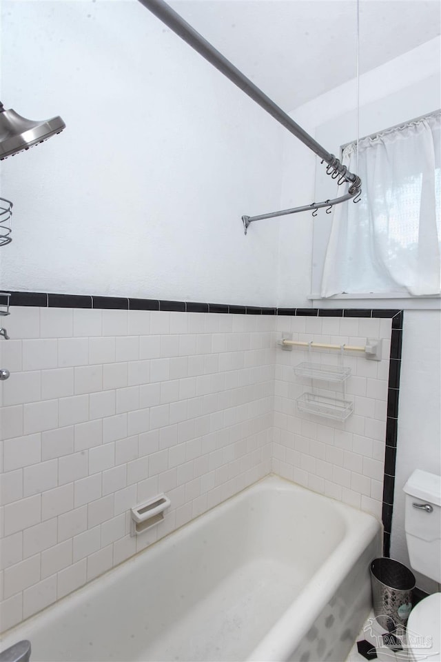 bathroom with shower / bath combination and toilet