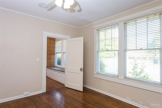 spare room featuring crown molding, ceiling fan, and dark hardwood / wood-style flooring