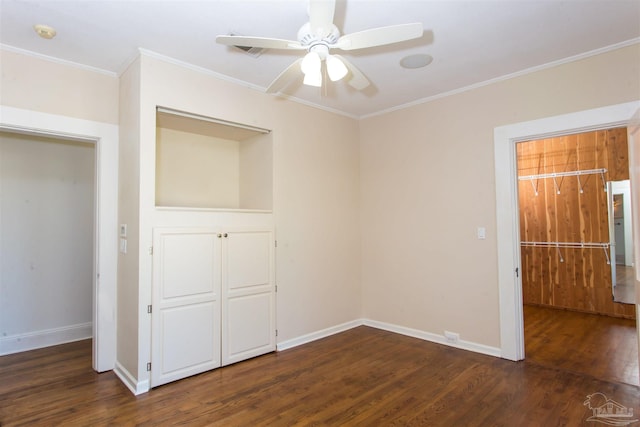 unfurnished bedroom featuring dark hardwood / wood-style flooring, ornamental molding, a closet, and ceiling fan