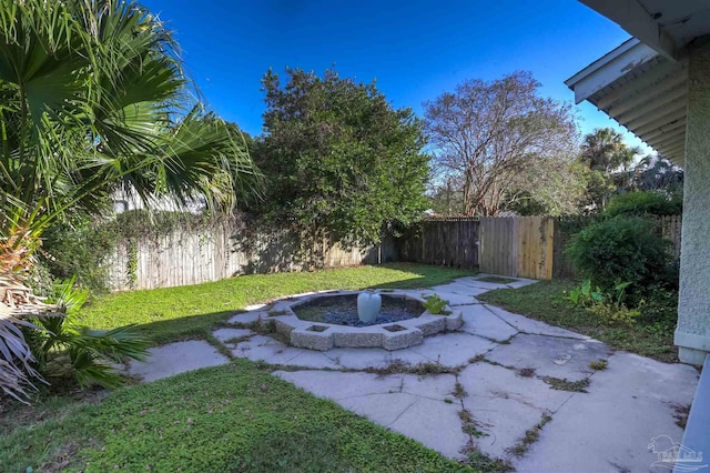 view of yard with a fire pit and a patio