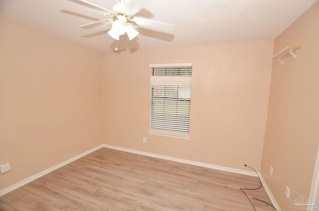 unfurnished room featuring light wood-style flooring, baseboards, ceiling fan, and a textured ceiling