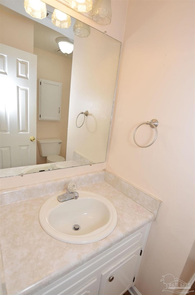 bathroom featuring toilet and vanity