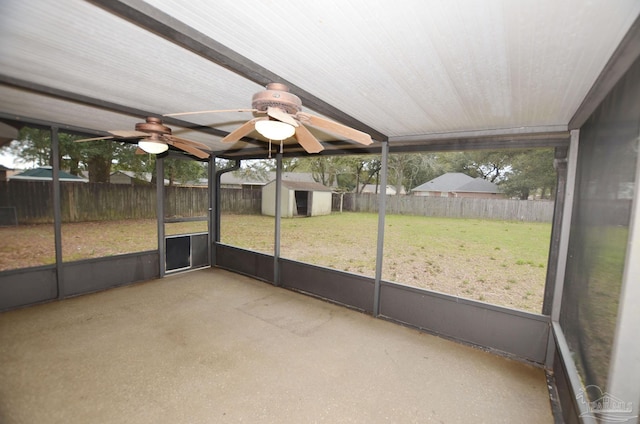 unfurnished sunroom featuring a ceiling fan