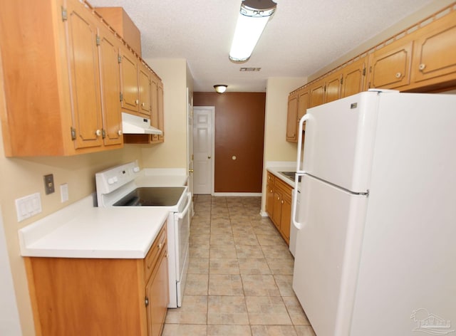 kitchen with a textured ceiling, under cabinet range hood, white appliances, visible vents, and light countertops