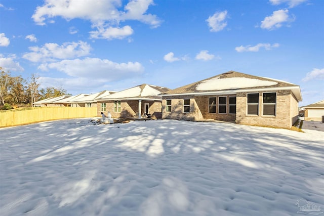 view of snow covered rear of property