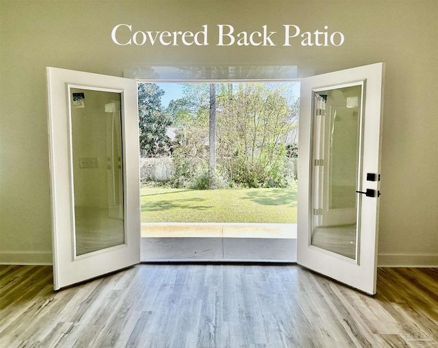1181 Adrian Way, Milton, FL 32583 - doorway featuring wood finished floors, baseboards, and french doors