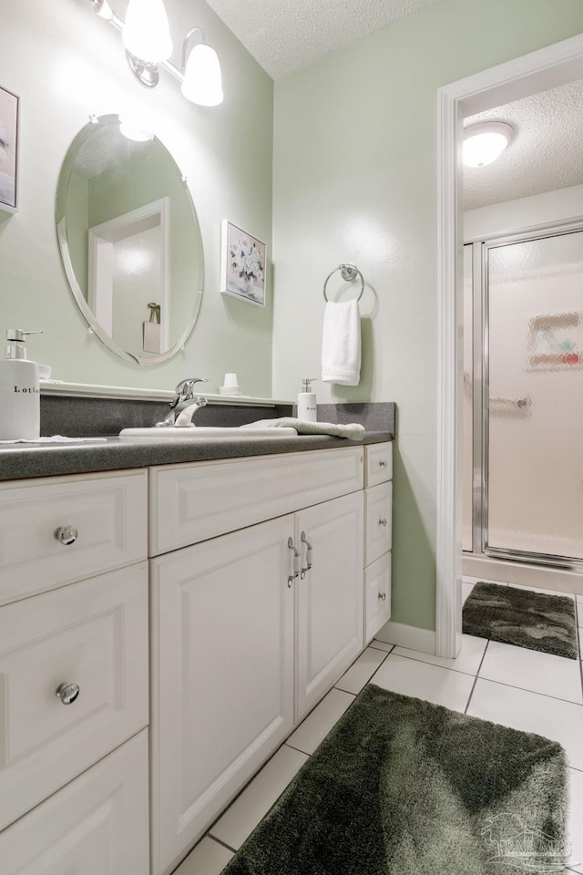 6028 Laurelwood Dr, Milton, FL 32570 - bathroom with a textured ceiling, tile patterned flooring, vanity, and a stall shower