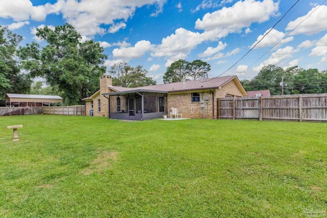 6028 Laurelwood Dr, Milton, FL 32570 - back of house featuring a sunroom, a chimney, and brick siding