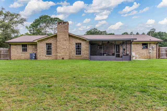 6028 Laurelwood Dr, Milton, FL 32570 - rear view of house featuring a sunroom, a chimney, a ceiling fan, cooling unit, and brick siding