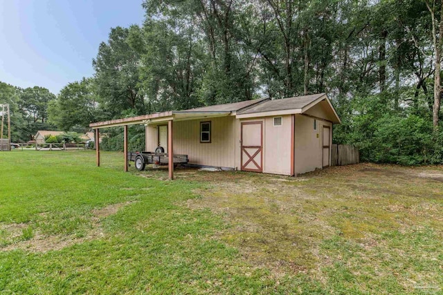 6028 Laurelwood Dr, Milton, FL 32570 - view of outdoor structure featuring a carport and view of wooded area