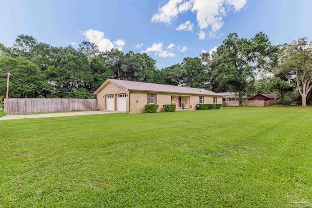6028 Laurelwood Dr, Milton, FL 32570 - ranch-style house featuring driveway, an attached garage, brick siding, and view of wooded area