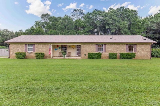 6028 Laurelwood Dr, Milton, FL 32570 - ranch-style house with a porch, a front lawn, brick siding, and a shingled roof
