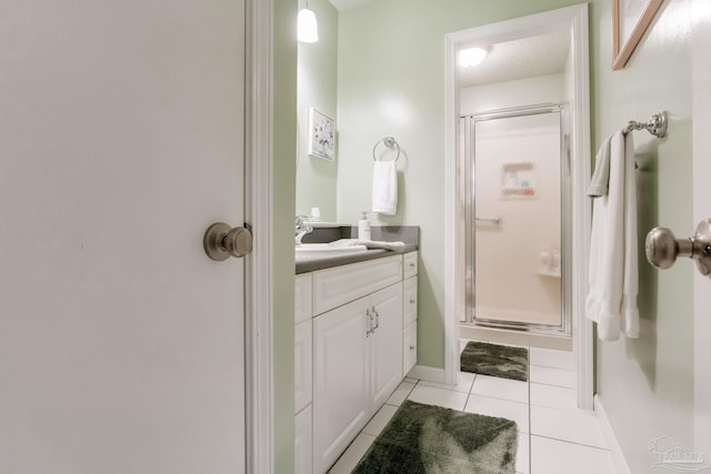 6028 Laurelwood Dr, Milton, FL 32570 - bathroom with vanity, a stall shower, tile patterned flooring, and baseboards