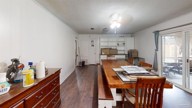 dining room with a textured ceiling, dark wood finished floors, and baseboards