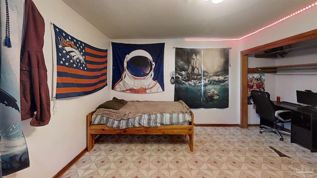 bedroom with light floors and baseboards