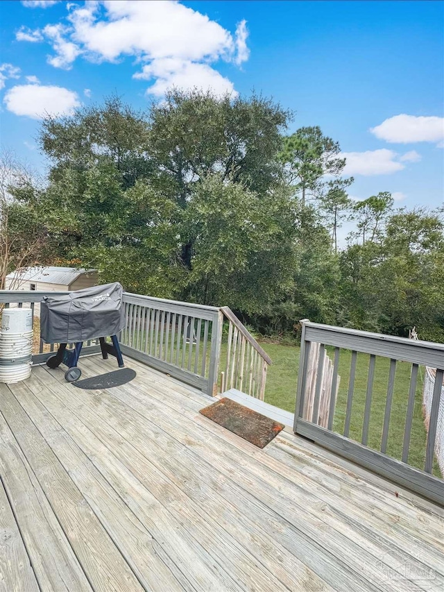 wooden deck featuring a yard