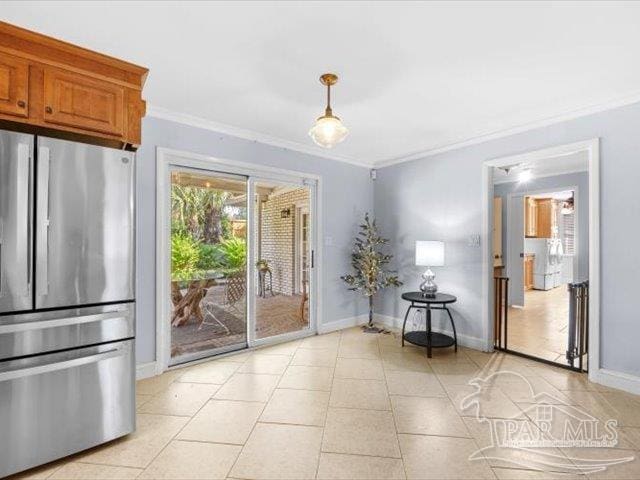 interior space with light tile patterned floors, crown molding, and a wealth of natural light