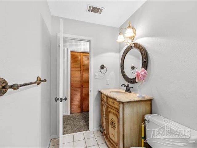 bathroom with vanity, tile patterned floors, and toilet