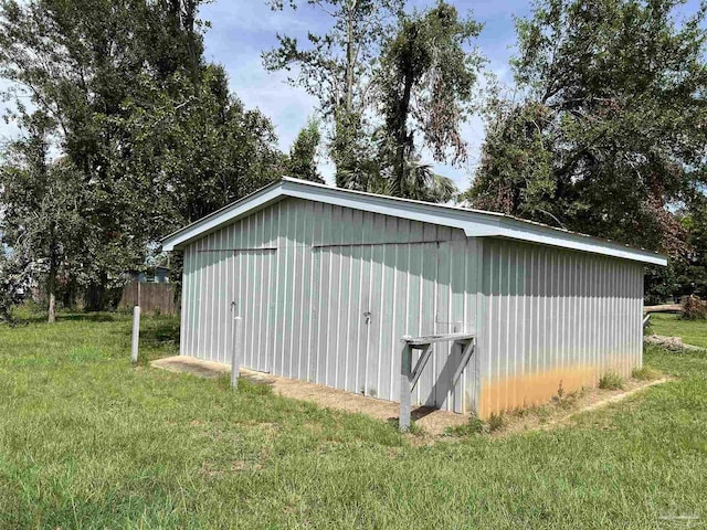 view of outbuilding featuring a yard