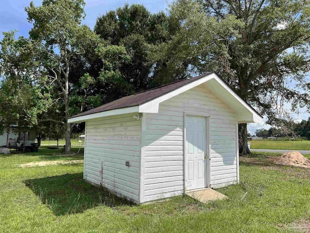 view of outbuilding featuring a yard