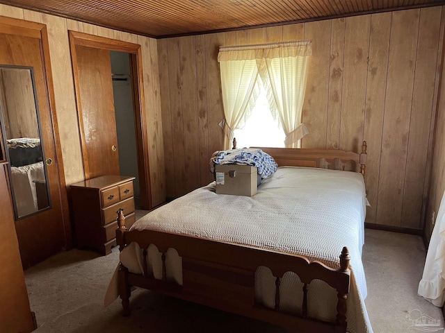 bedroom featuring wood ceiling, wooden walls, and carpet floors