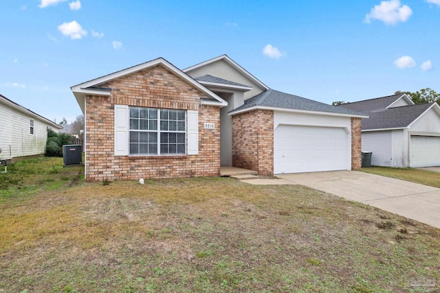 view of front of home with a front lawn, a garage, and central AC