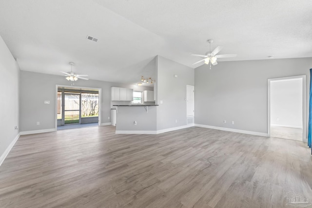 1548 Joseph Cir, Gulf Breeze, FL 32563 - unfurnished living room with light wood-style flooring, ceiling fan, and vaulted ceiling