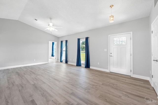 1548 Joseph Cir, Gulf Breeze, FL 32563 - interior space featuring a textured ceiling, light wood-style floors, a ceiling fan, and vaulted ceiling