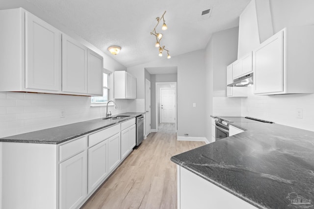 1548 Joseph Cir, Gulf Breeze, FL 32563 - kitchen with under cabinet range hood, dark stone counters, appliances with stainless steel finishes, and visible vents