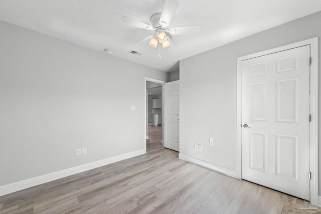 1548 Joseph Cir, Gulf Breeze, FL 32563 - unfurnished bedroom featuring visible vents, a ceiling fan, a textured ceiling, wood finished floors, and baseboards