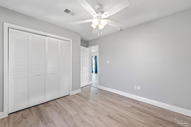 1548 Joseph Cir, Gulf Breeze, FL 32563 - unfurnished bedroom featuring wood finished floors, visible vents, baseboards, ceiling fan, and a closet