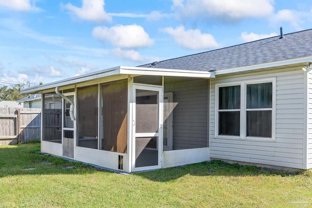 1548 Joseph Cir, Gulf Breeze, FL 32563 - back of house with a lawn, fence, a sunroom, and roof with shingles