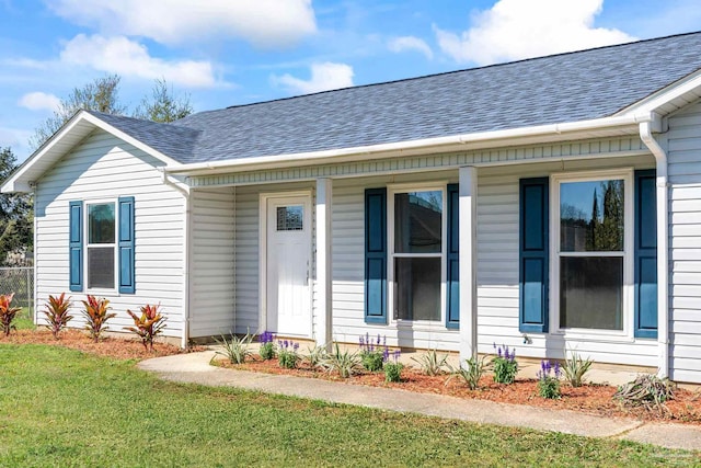 1548 Joseph Cir, Gulf Breeze, FL 32563 - view of exterior entry with a lawn and roof with shingles