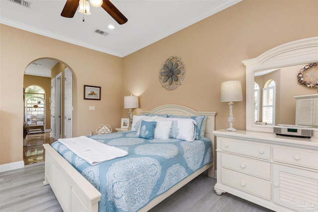 2792 Pga Blvd, Navarre, FL 32566 - bedroom featuring light wood-type flooring, arched walkways, ceiling fan, ornamental molding, and recessed lighting