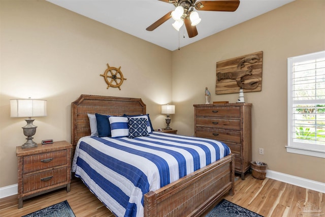 2792 Pga Blvd, Navarre, FL 32566 - bedroom with baseboards, wood finished floors, and a ceiling fan
