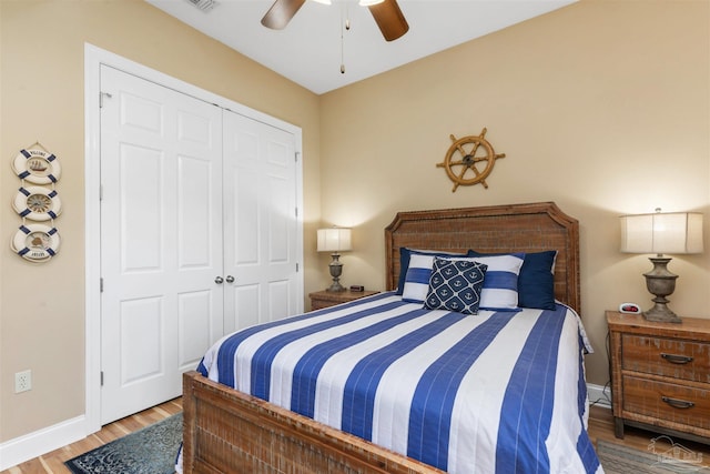 2792 Pga Blvd, Navarre, FL 32566 - bedroom with baseboards, wood finished floors, a closet, and a ceiling fan