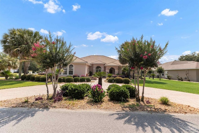 2792 Pga Blvd, Navarre, FL 32566 - view of front of property with a front lawn, curved driveway, and stucco siding