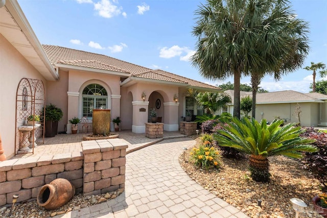 2792 Pga Blvd, Navarre, FL 32566 - entrance to property with stucco siding and a tiled roof