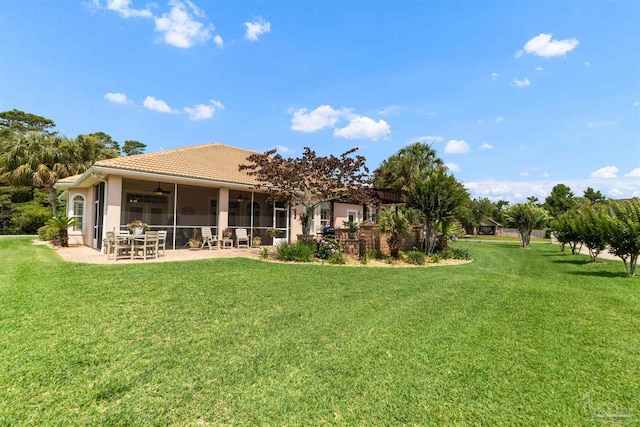 2792 Pga Blvd, Navarre, FL 32566 - rear view of house with a ceiling fan, a lawn, a patio area, and a tiled roof